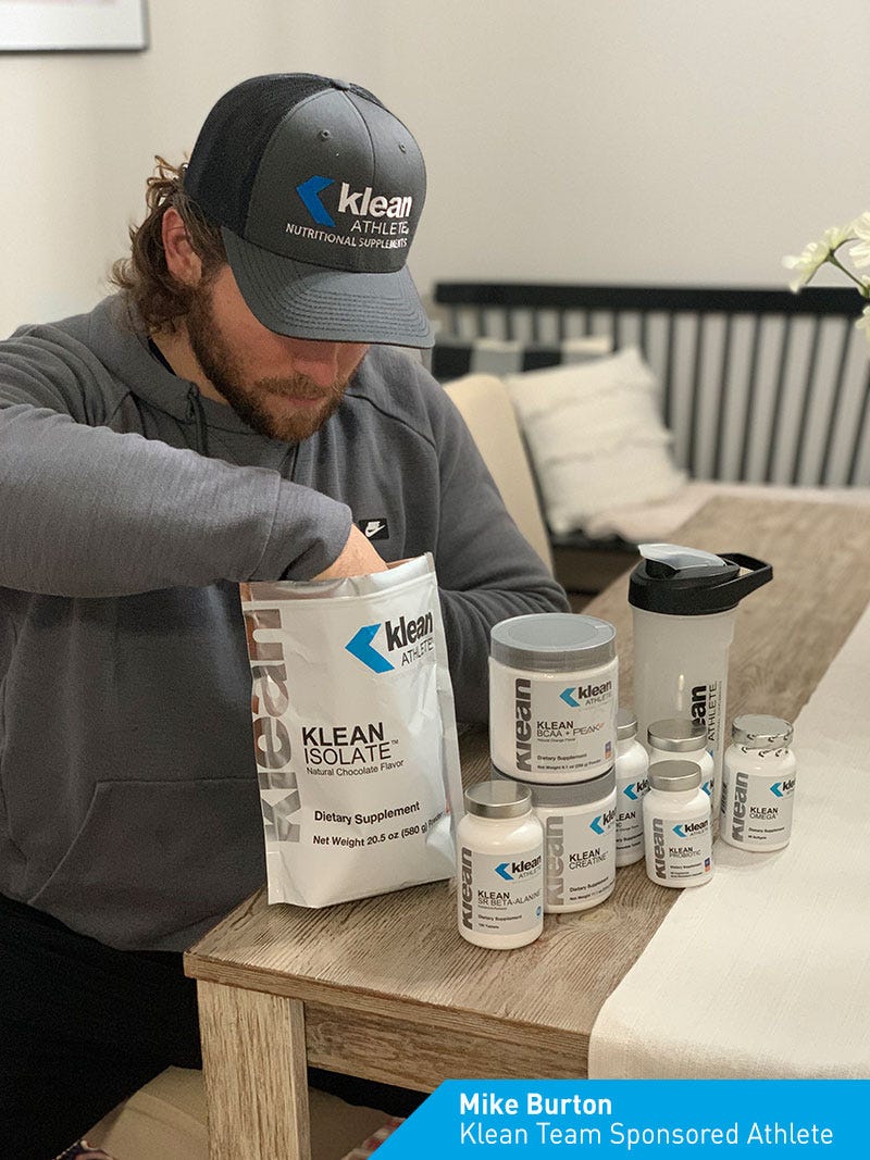 Image of Klean team sponsored athlete Mike Burton with Klean Athlete supplements at a table